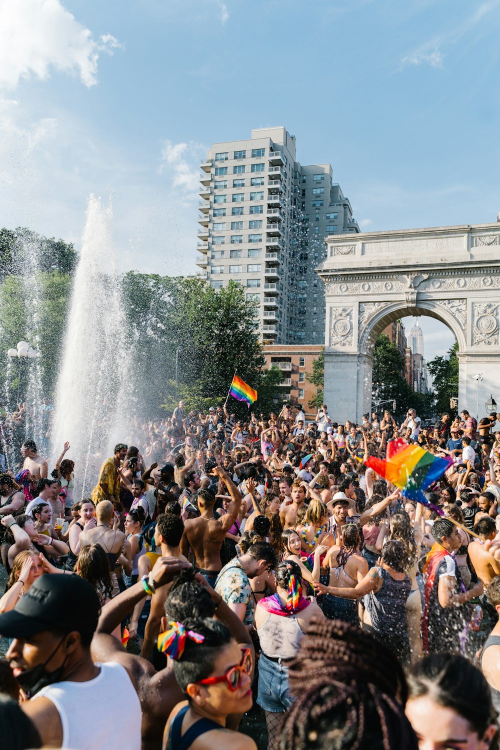 people gathering near fountain during daytime