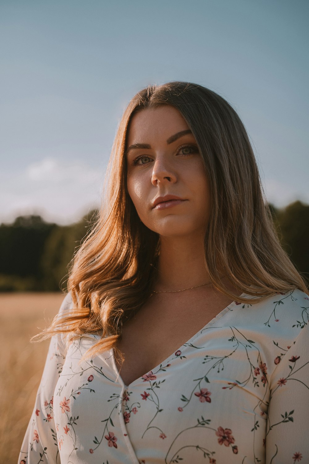 woman in white and blue floral shirt