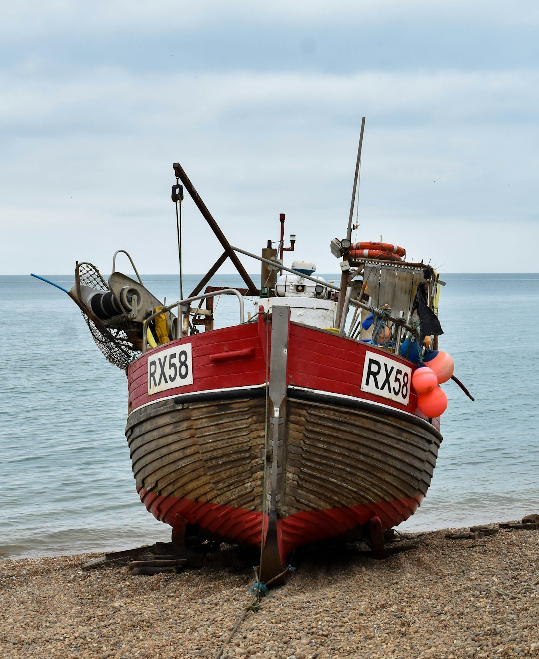 red and white boat on beach during daytime