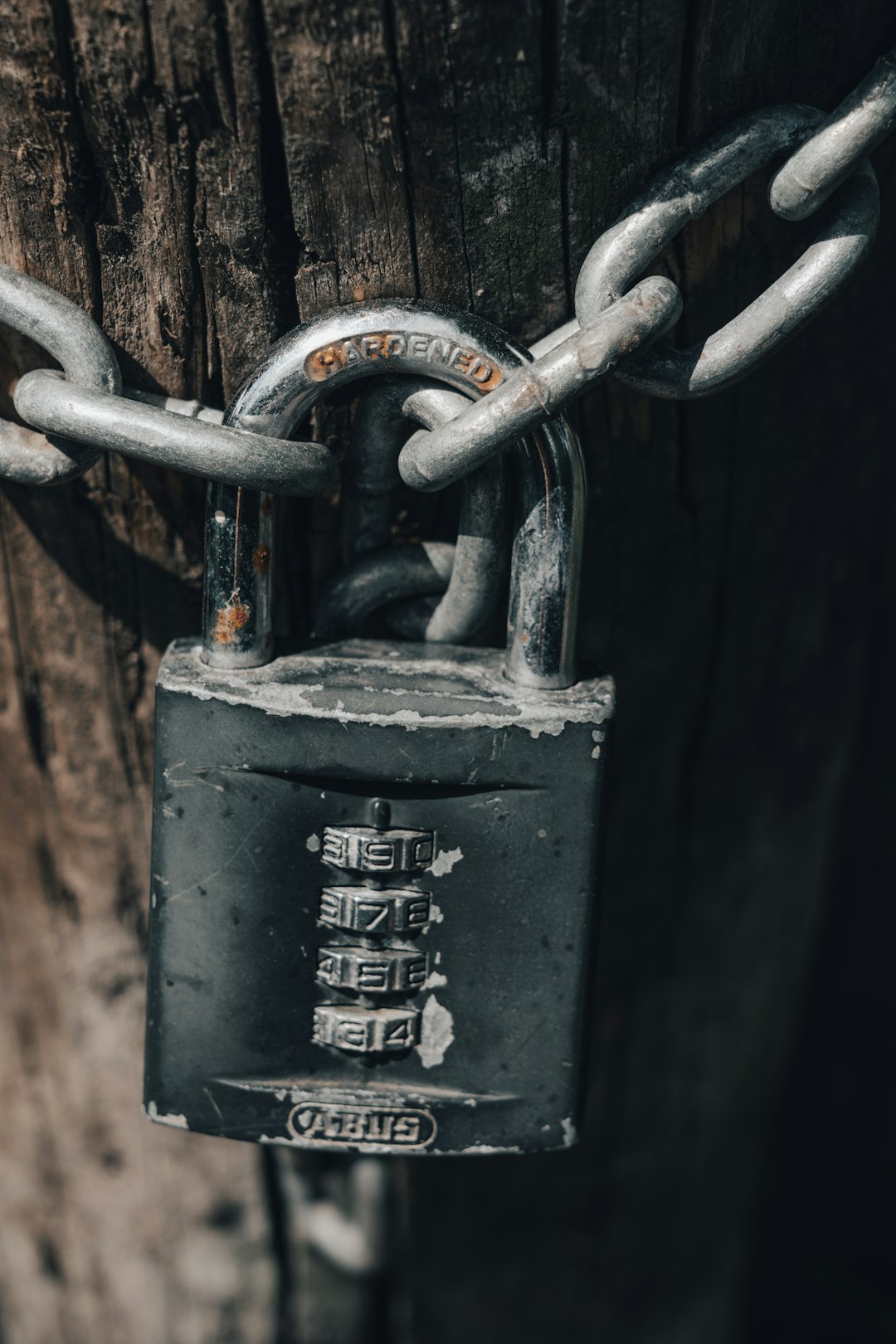 gray padlock on brown steel chain