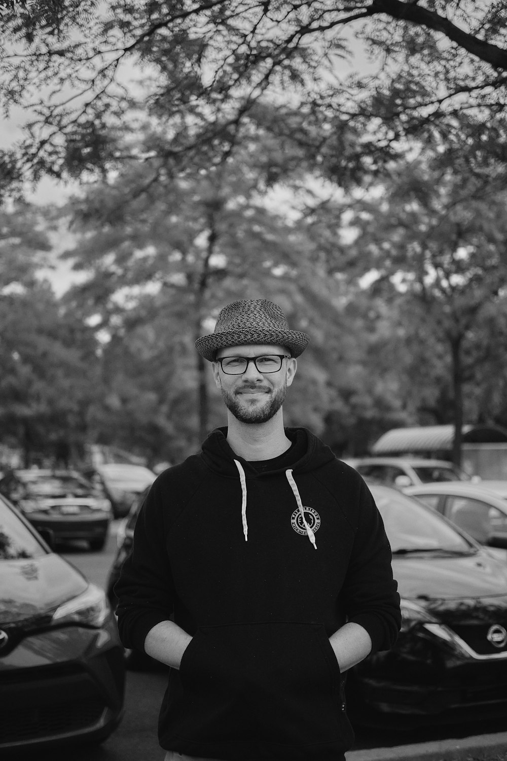 grayscale photo of man in black hoodie and knit cap