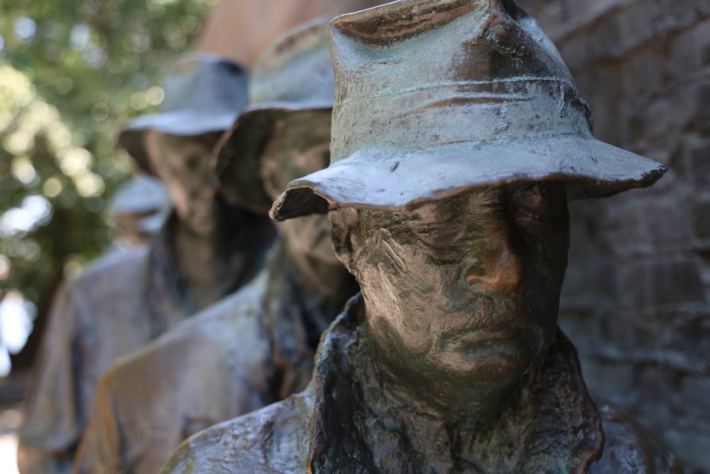 man in white hat statue