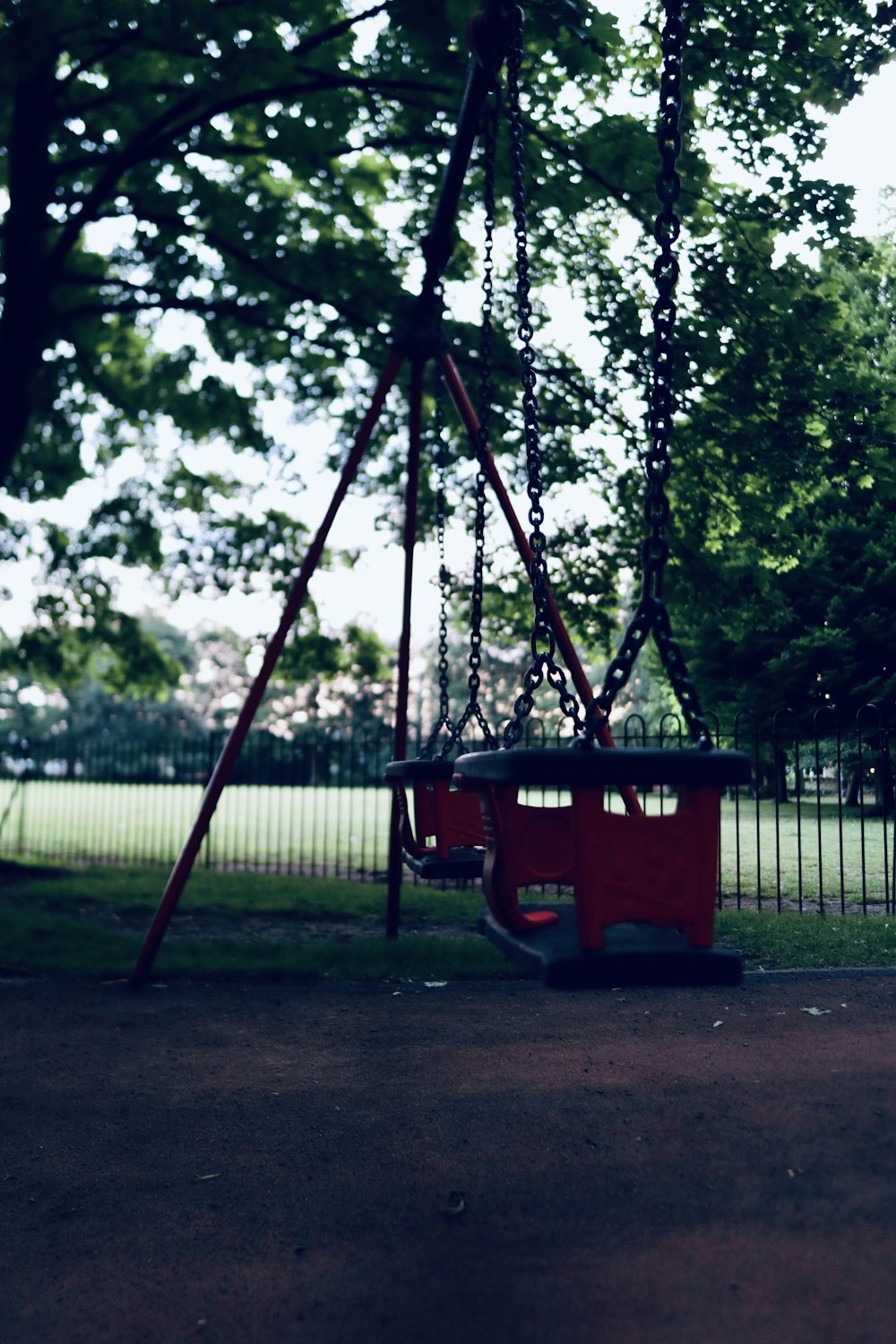 red and black swing near green trees during daytime photo – Free Longford  park Image on Unsplash