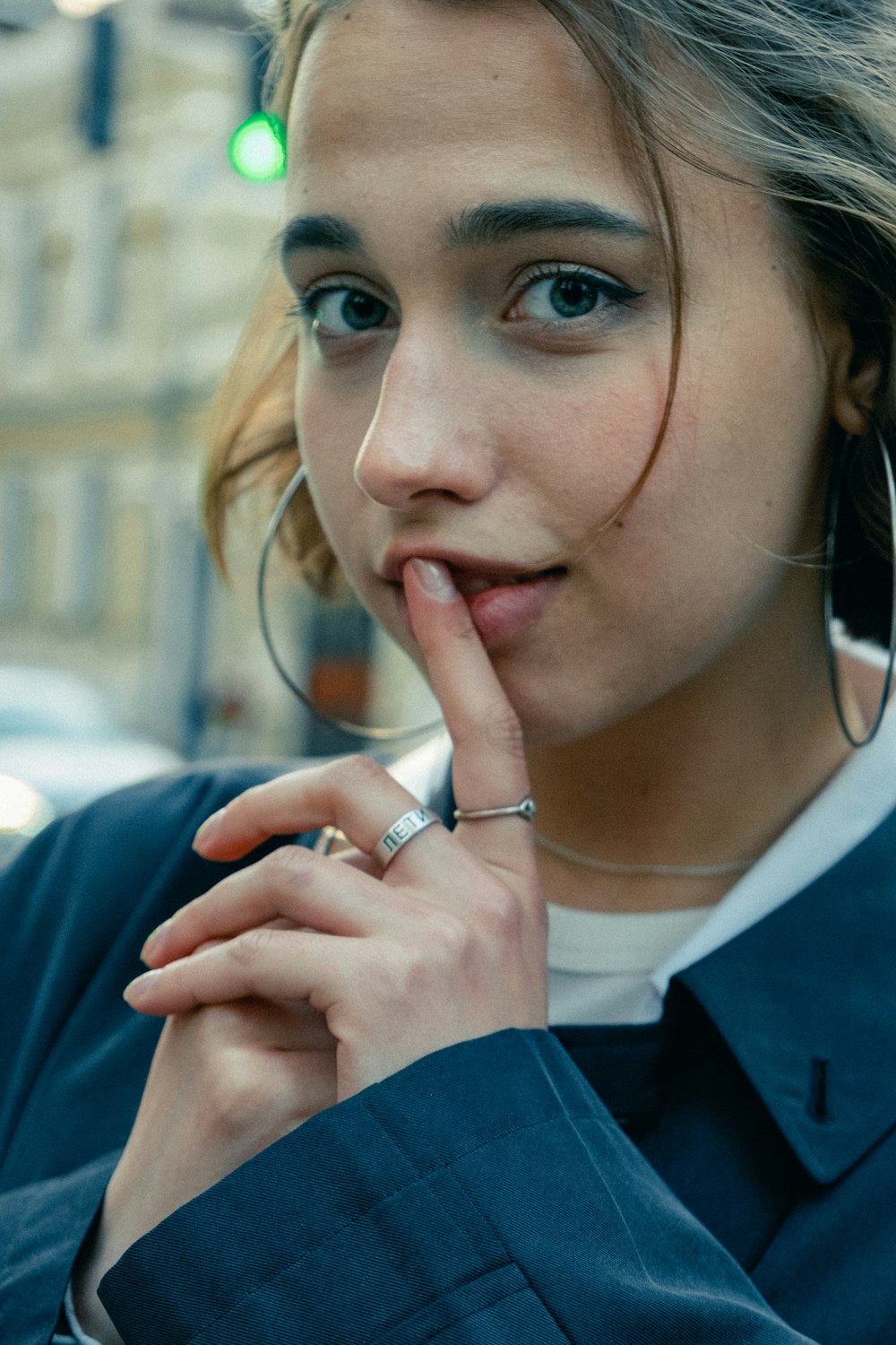 woman in blue blazer wearing silver ring