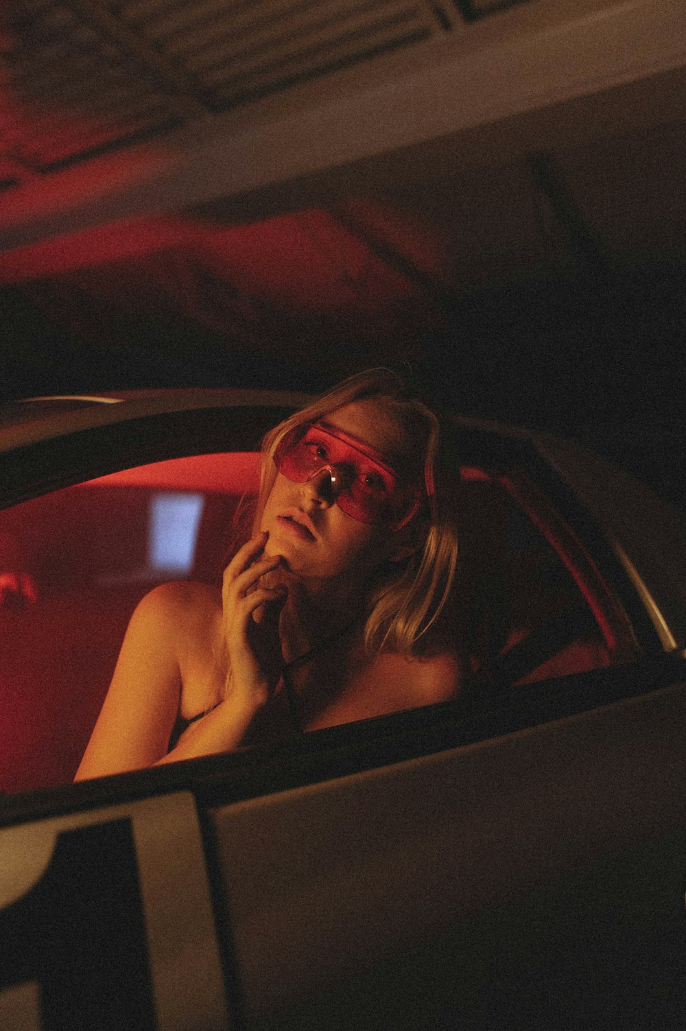 woman in black framed eyeglasses sitting inside car