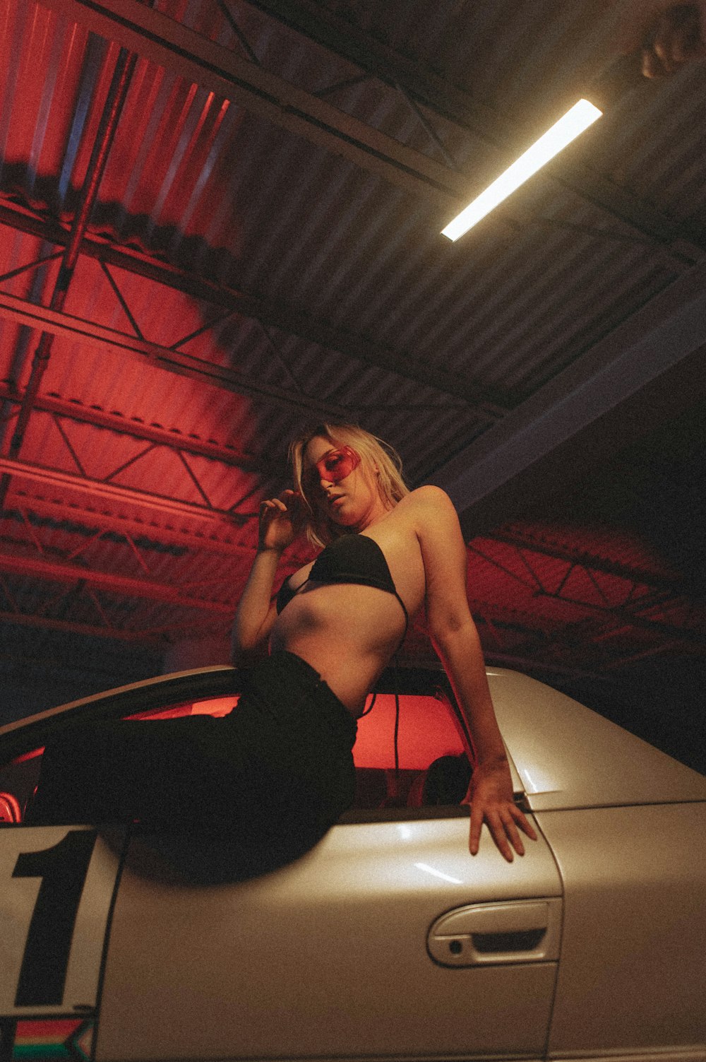 woman in black sports bra and black leggings sitting on white chair