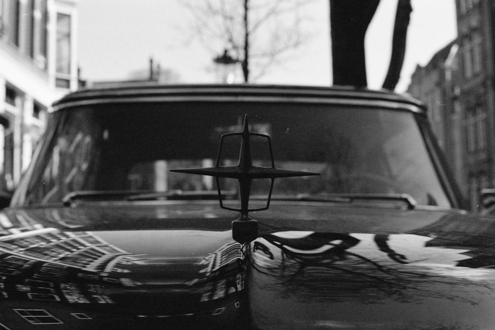 grayscale photo of car with broken window
