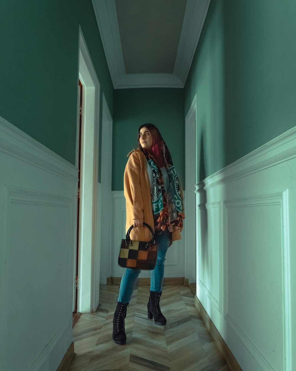 woman in white cardigan standing on hallway