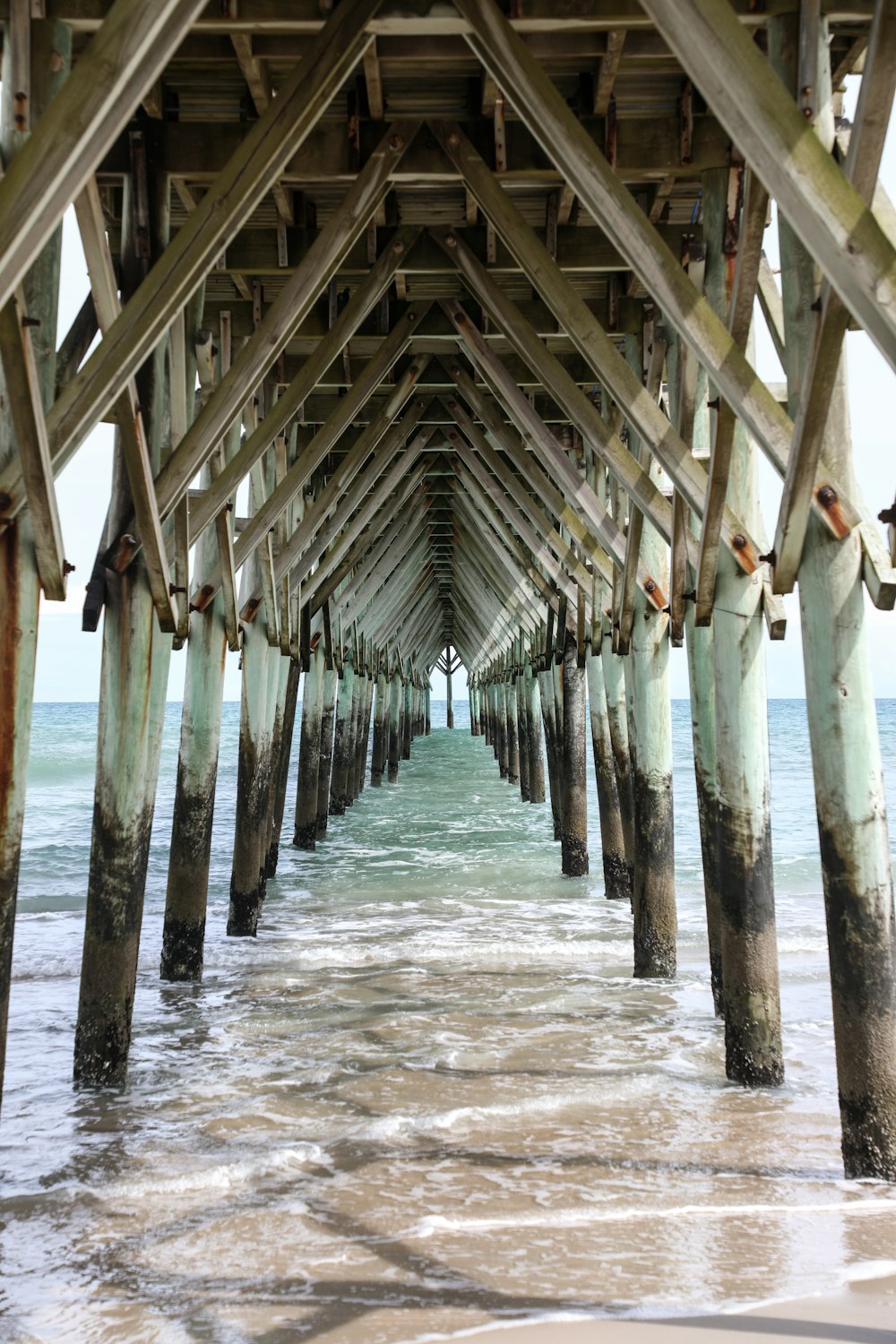 brown wooden dock on body of water during daytime