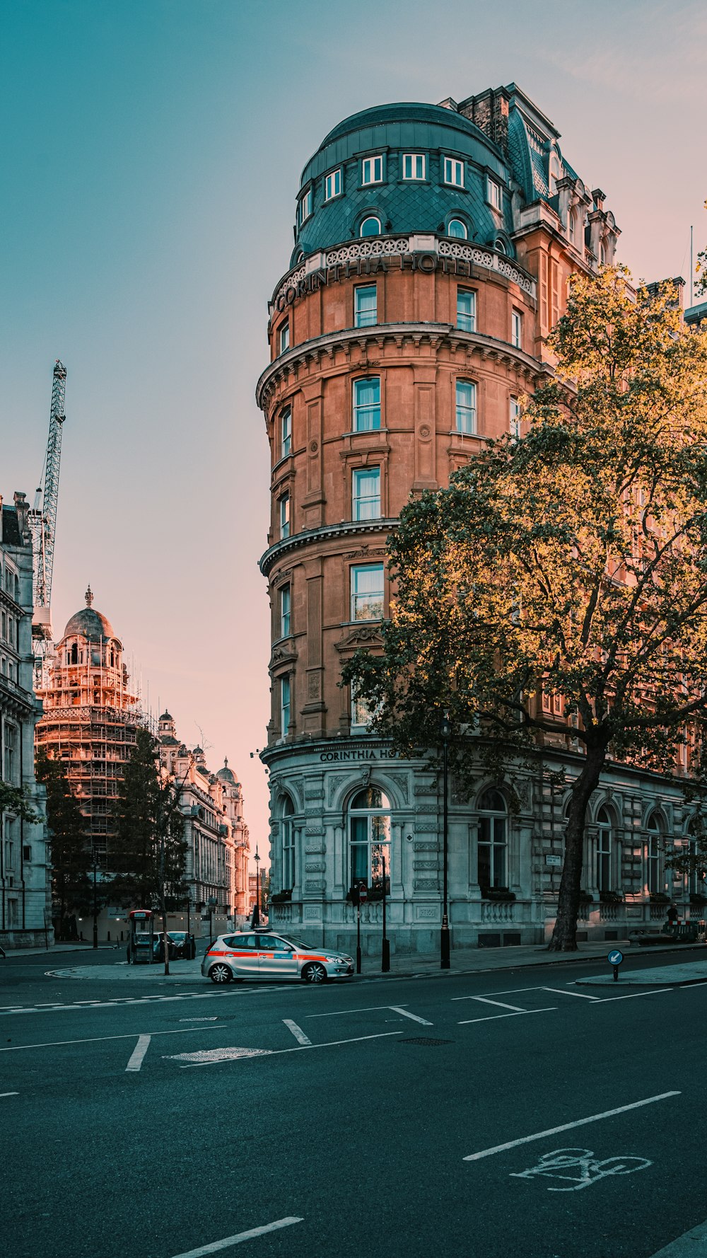 brown concrete building near green trees during daytime