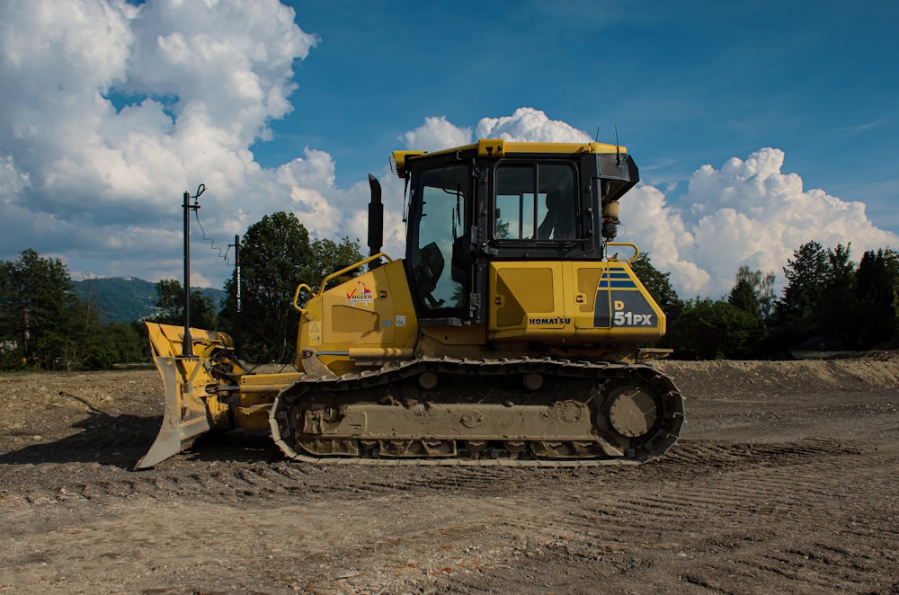 yellow and black heavy equipment on gray sand during daytime