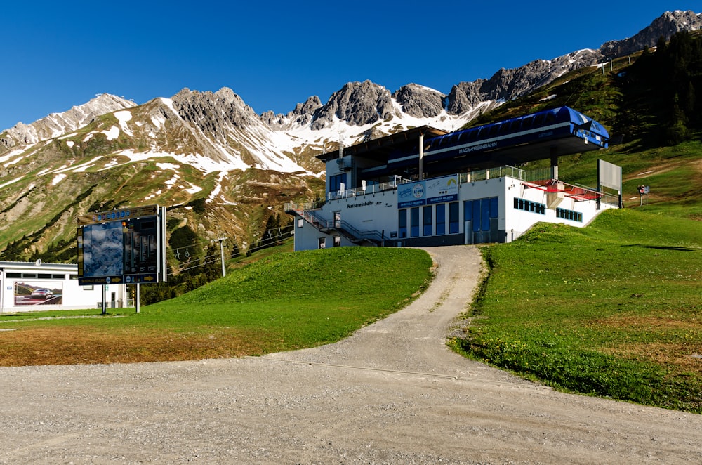 white and black house near mountain under blue sky during daytime