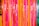 Bright and colorful vertical streamers in vibrant shades of pink, orange, and green create a festive and lively atmosphere.