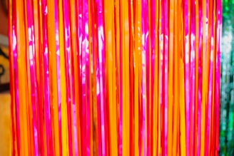 Colorful spiral streamers cascading down a festive wall.