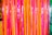 Bright and colorful vertical streamers in vibrant shades of pink, orange, and green create a festive and lively atmosphere.
