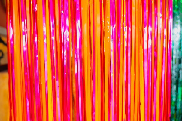 Colorful spiral streamers cascading down a festive wall.