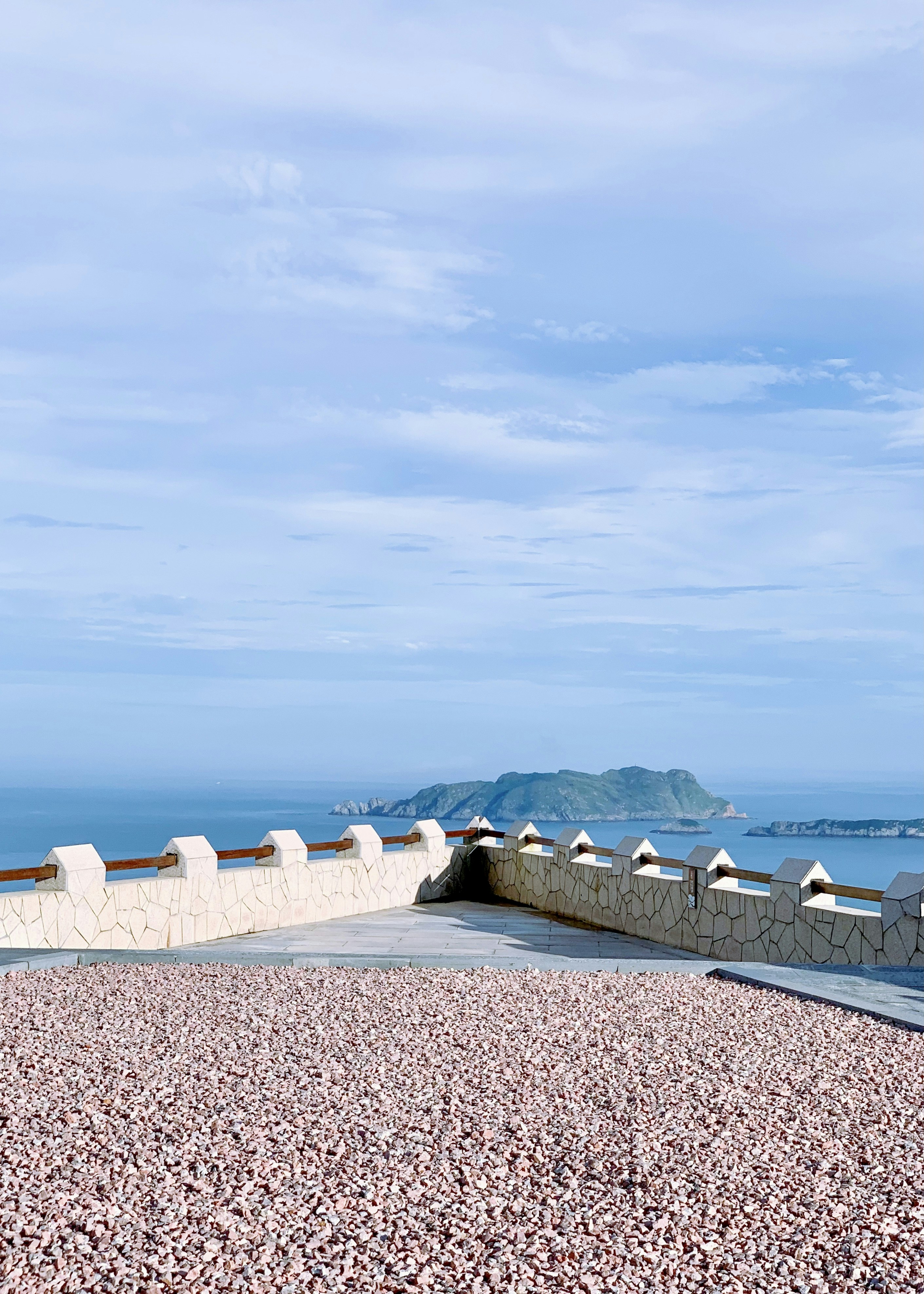white and gray concrete wall near body of water during daytime