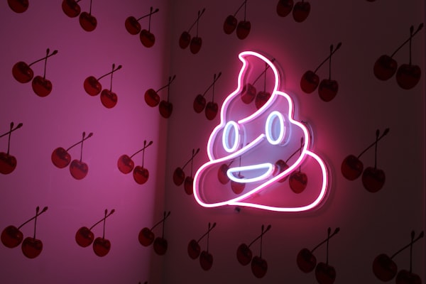 pink neon poop emoji sign