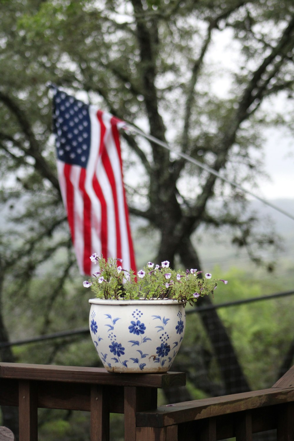 us a flag on white and blue floral ceramic vase