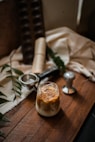 stainless steel spoon beside clear glass cup