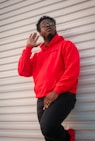 man in red dress shirt and blue denim jeans