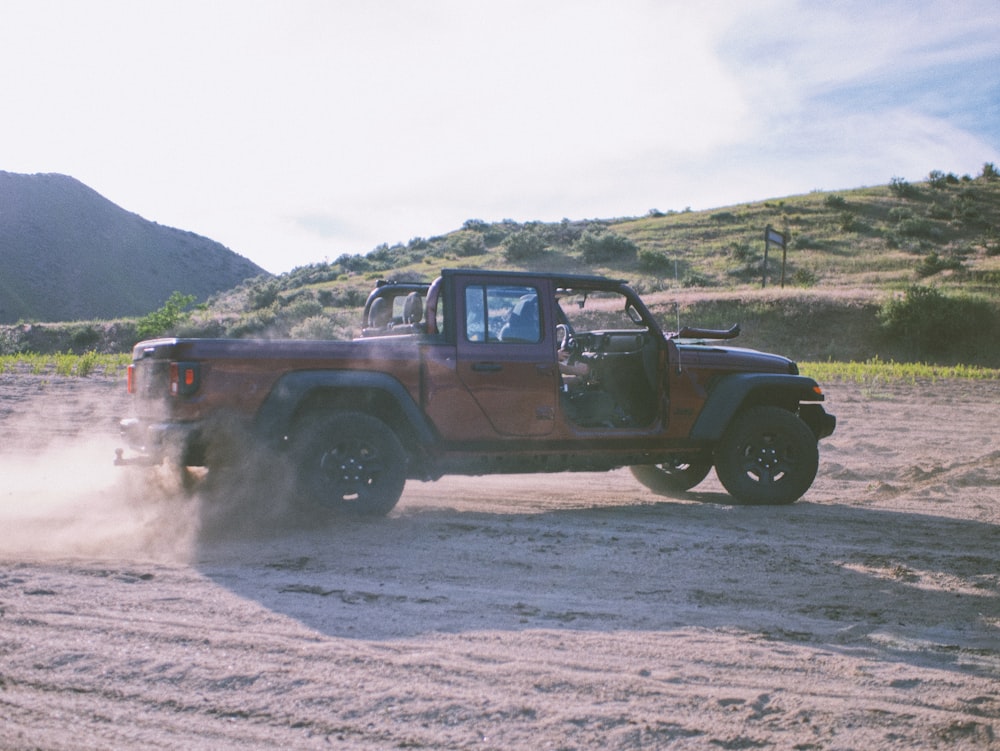 brown suv on brown dirt road during daytime