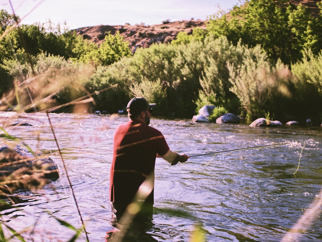 woman in red shirt and black shorts on water during daytime