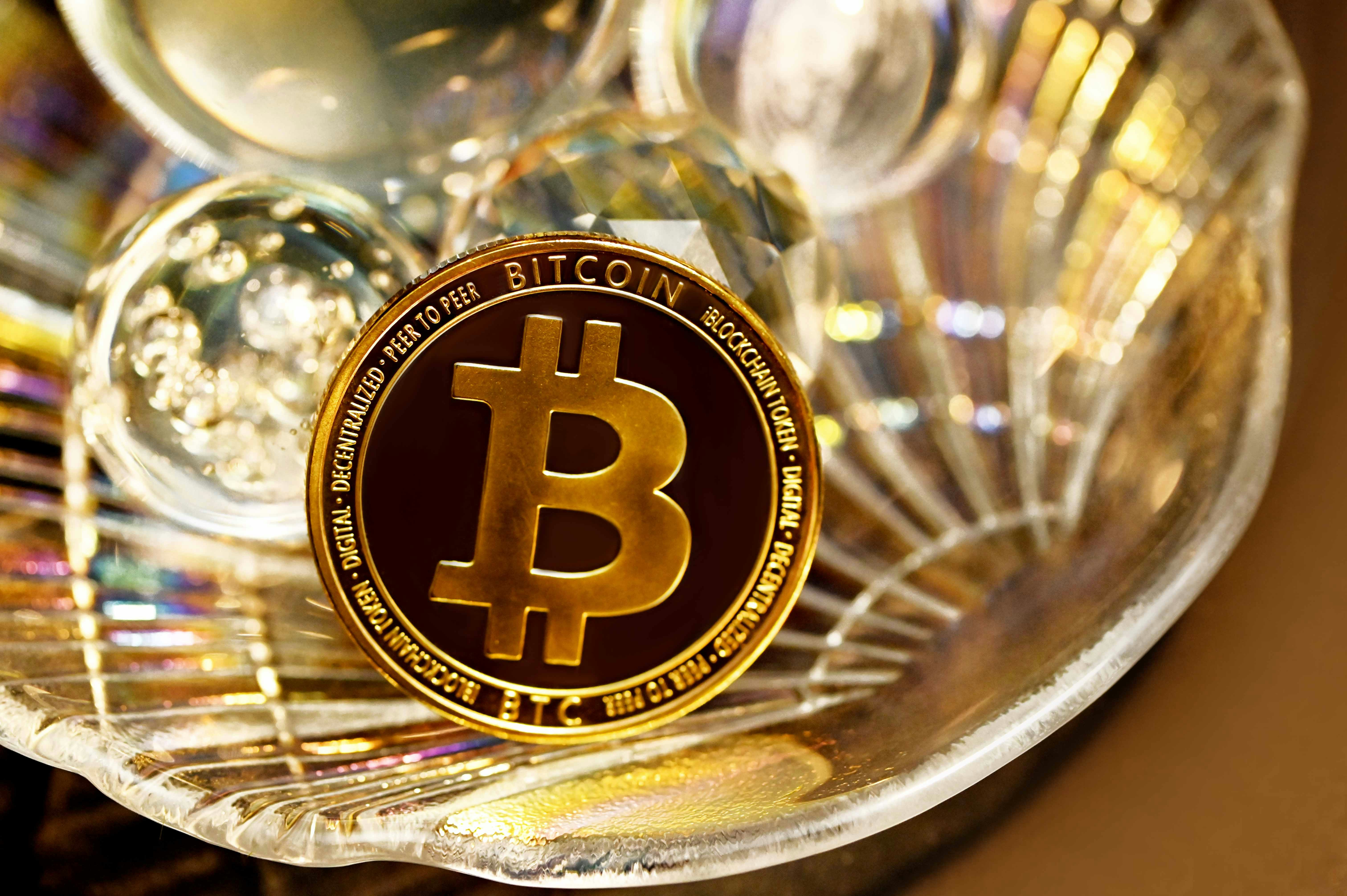 A bitcoin in a glass shell plate with crystal balls