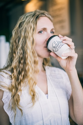Relaxed client enjoying a beverage in the welcoming beauty and style lounge.