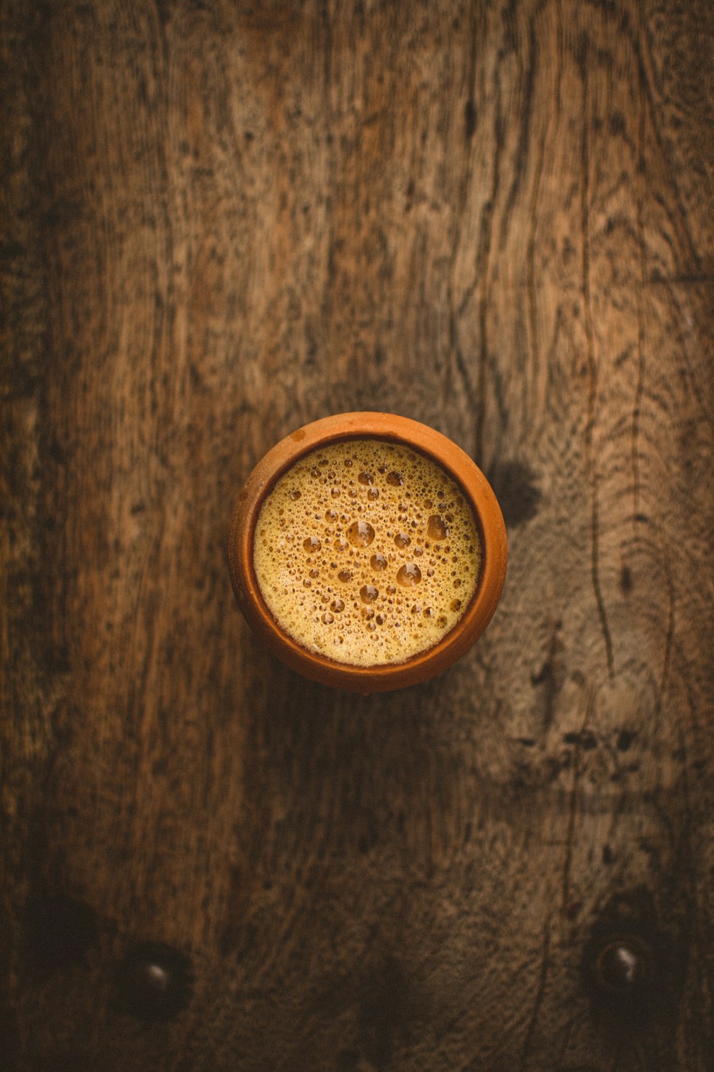 brown round container on brown wooden table