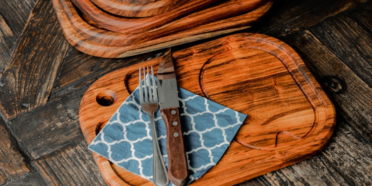 brown wooden chopping board on brown wooden table