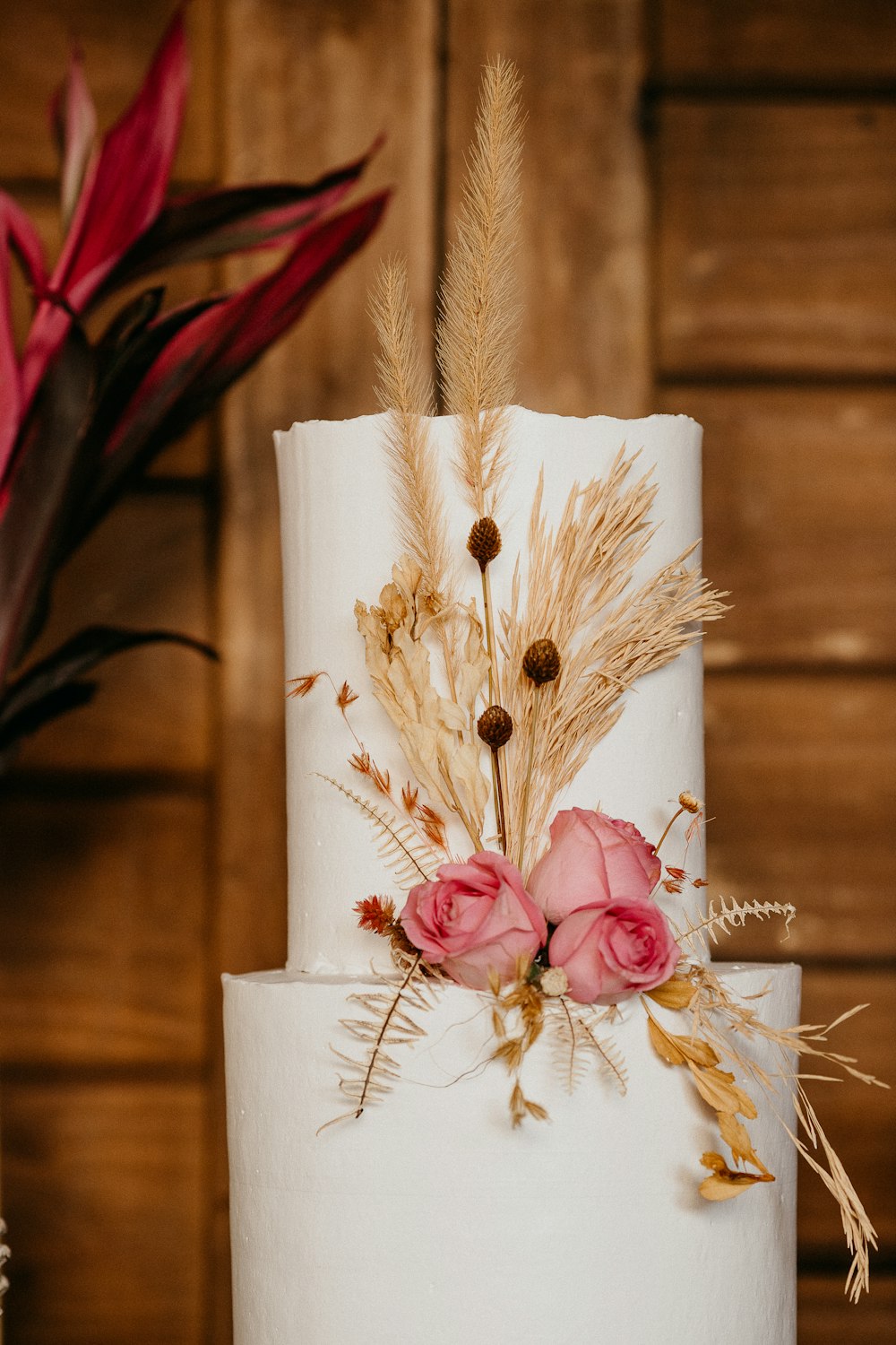 white and pink flower on white candle holder