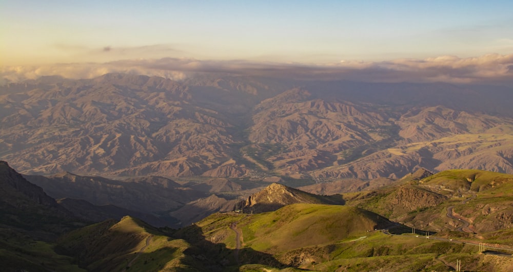 aerial view of green and brown mountains during daytime