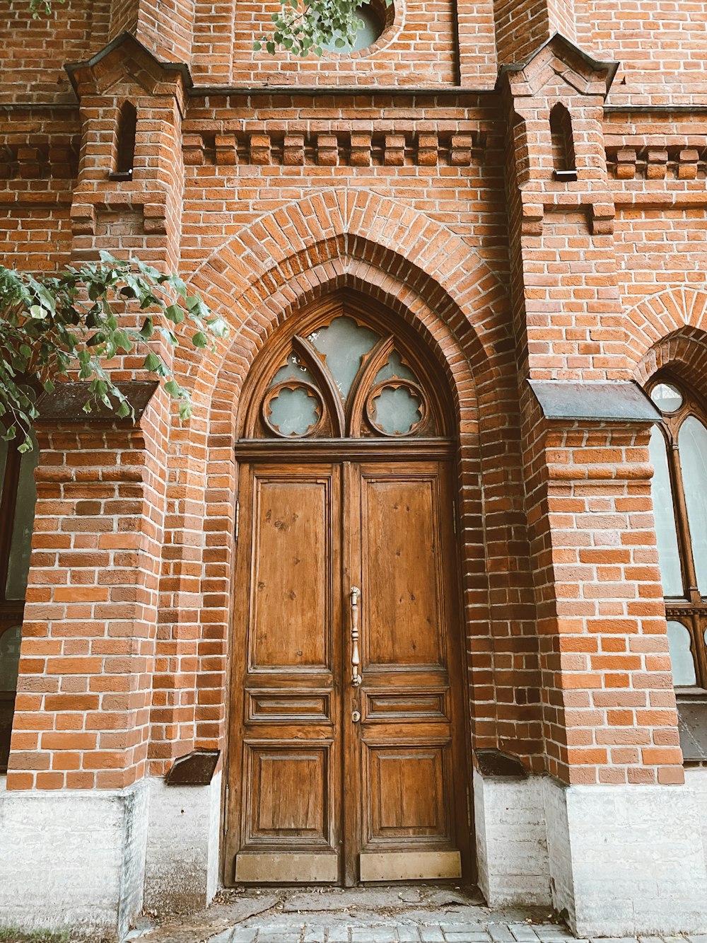 brown wooden door on brown brick building