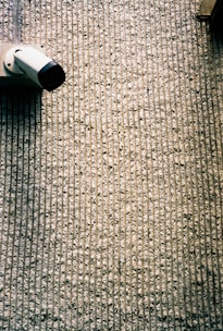 white and black tube bottle on gray textile