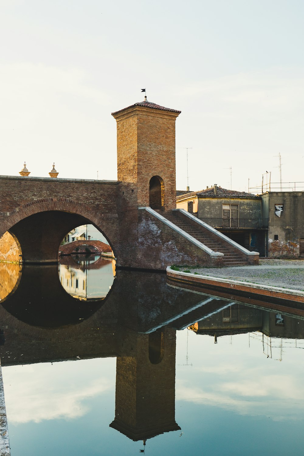 brown and gray concrete bridge over river during daytime