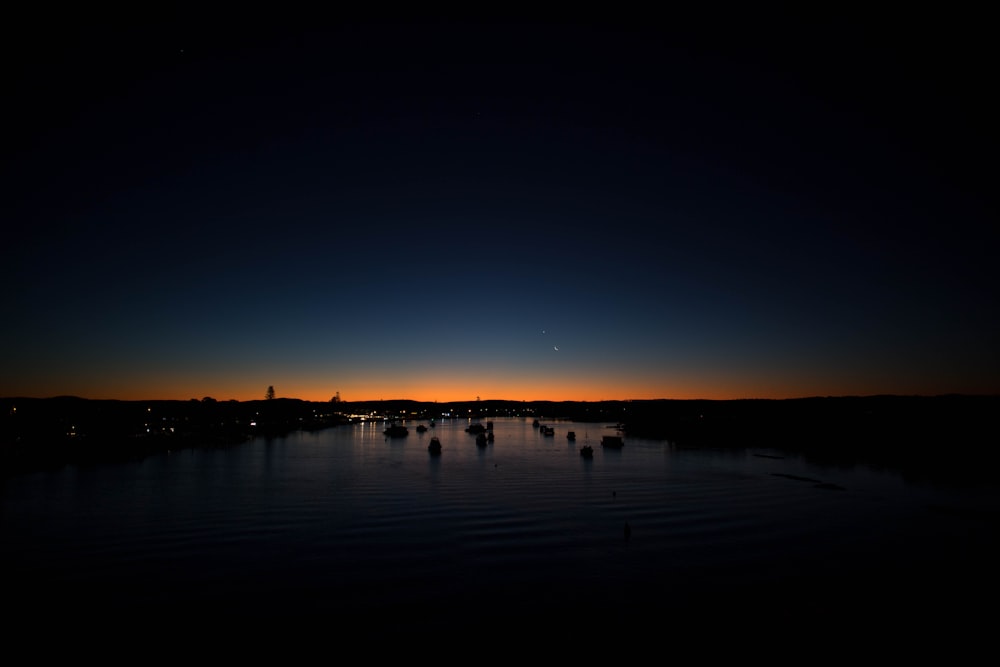 silhouette of people on beach during night time