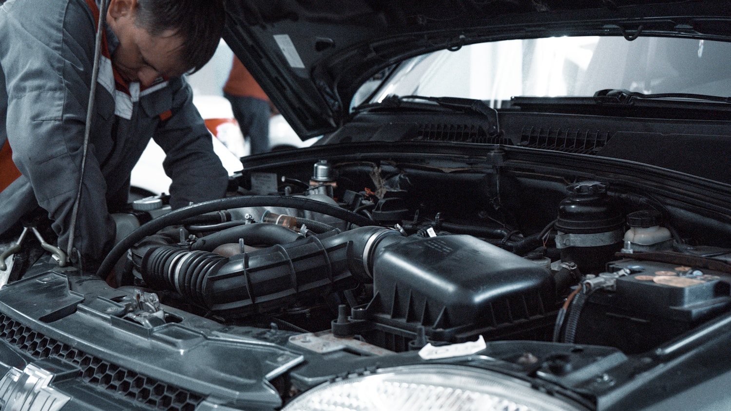 Mechanic working on a car engine