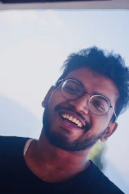 Close-up of smiling young streamer creating a relaxed, casual atmosphere.