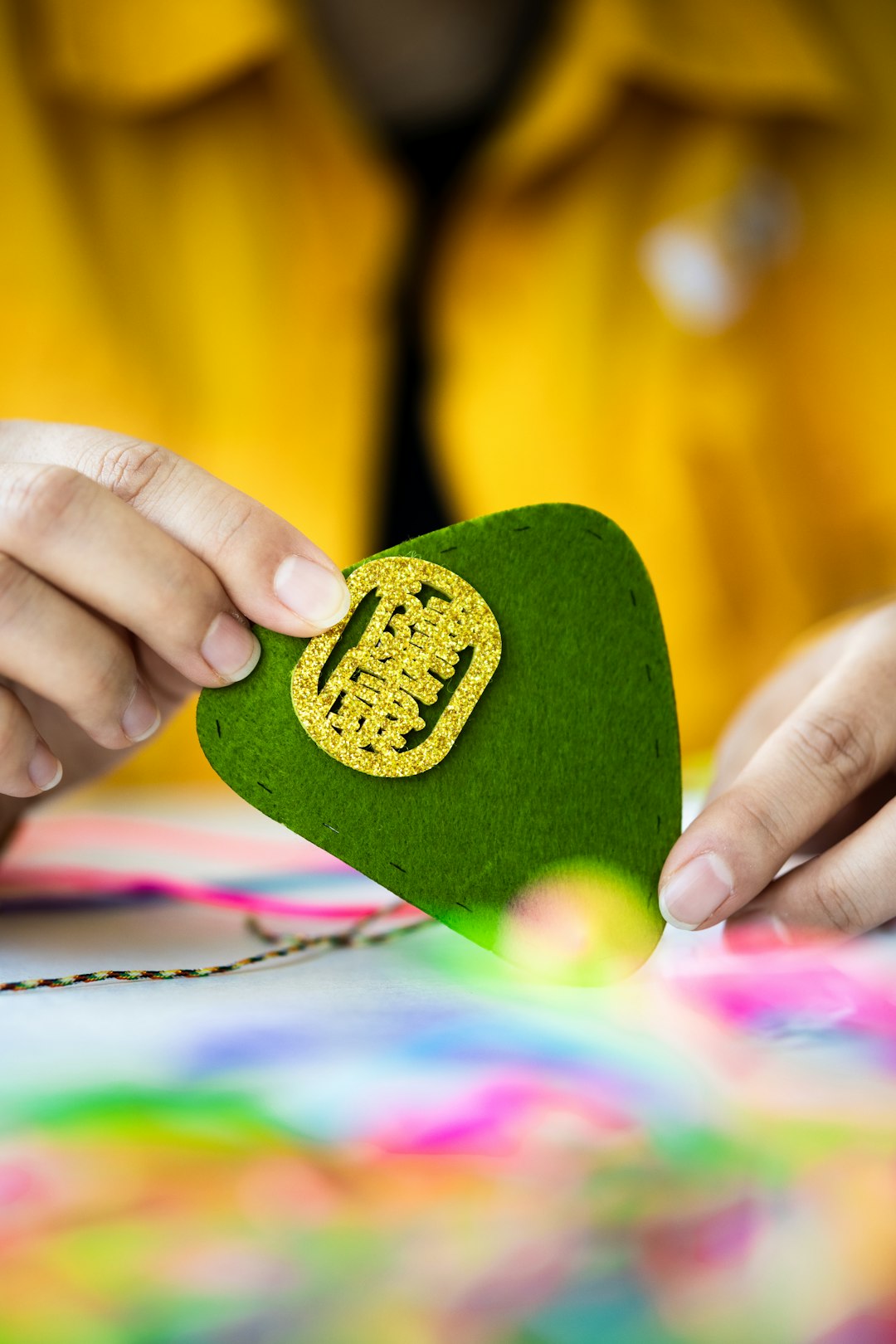 person holding green heart shaped ornament