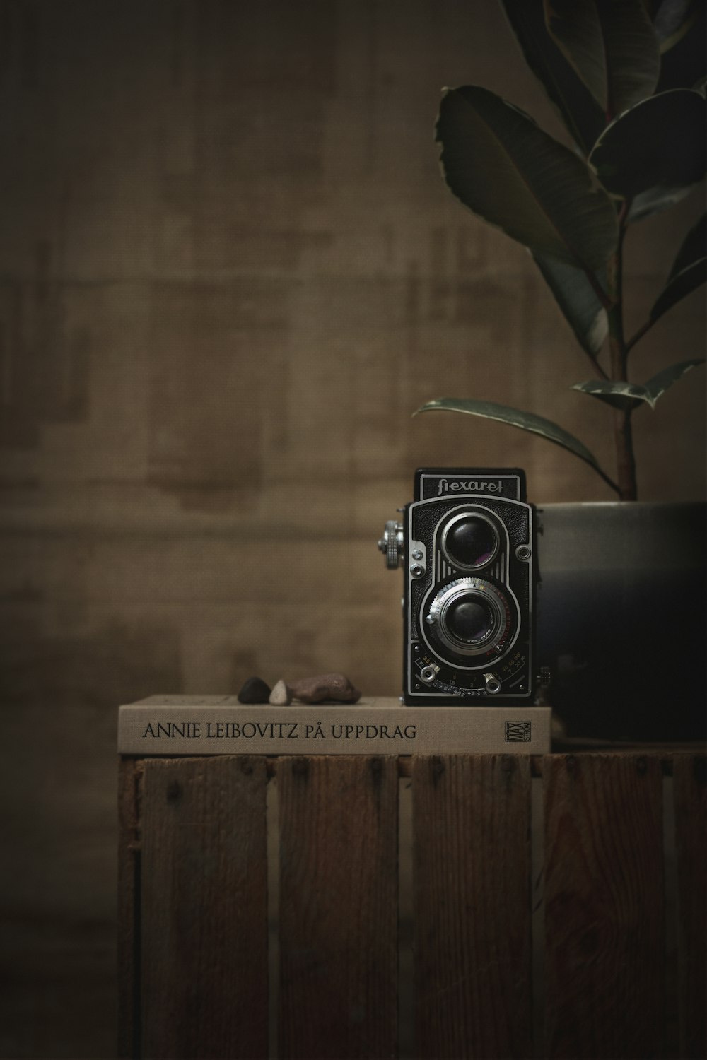 black and silver camera on brown wooden table