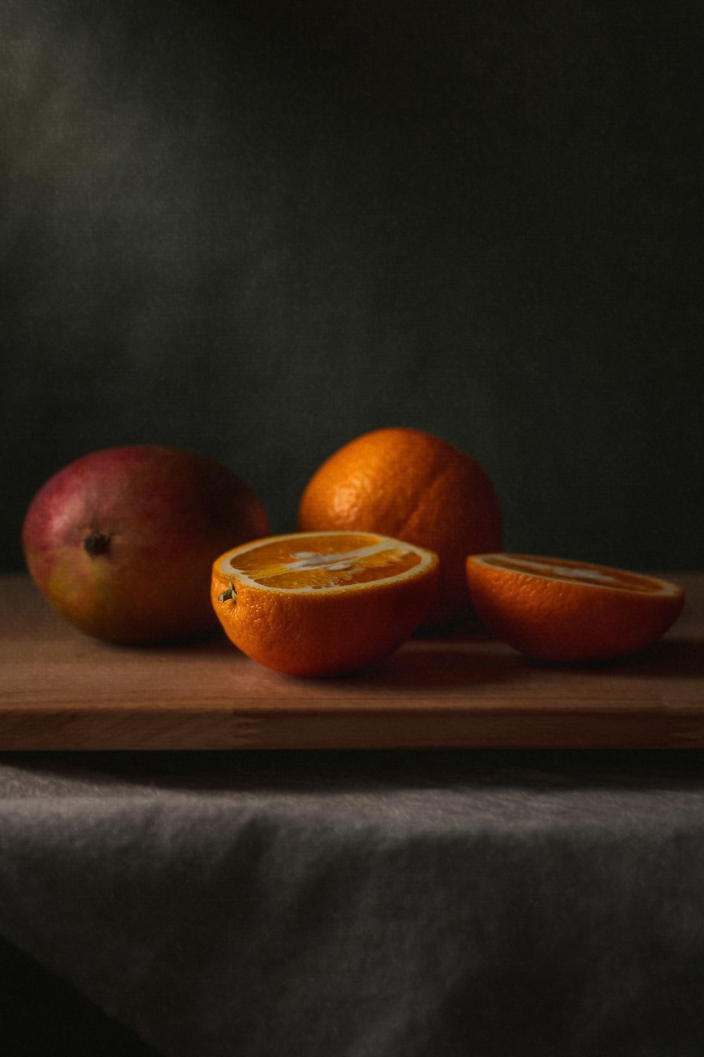 3 red apples on brown wooden chopping board