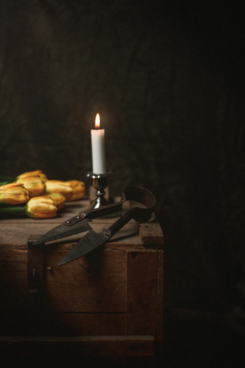 brown wooden chopping board with white candles