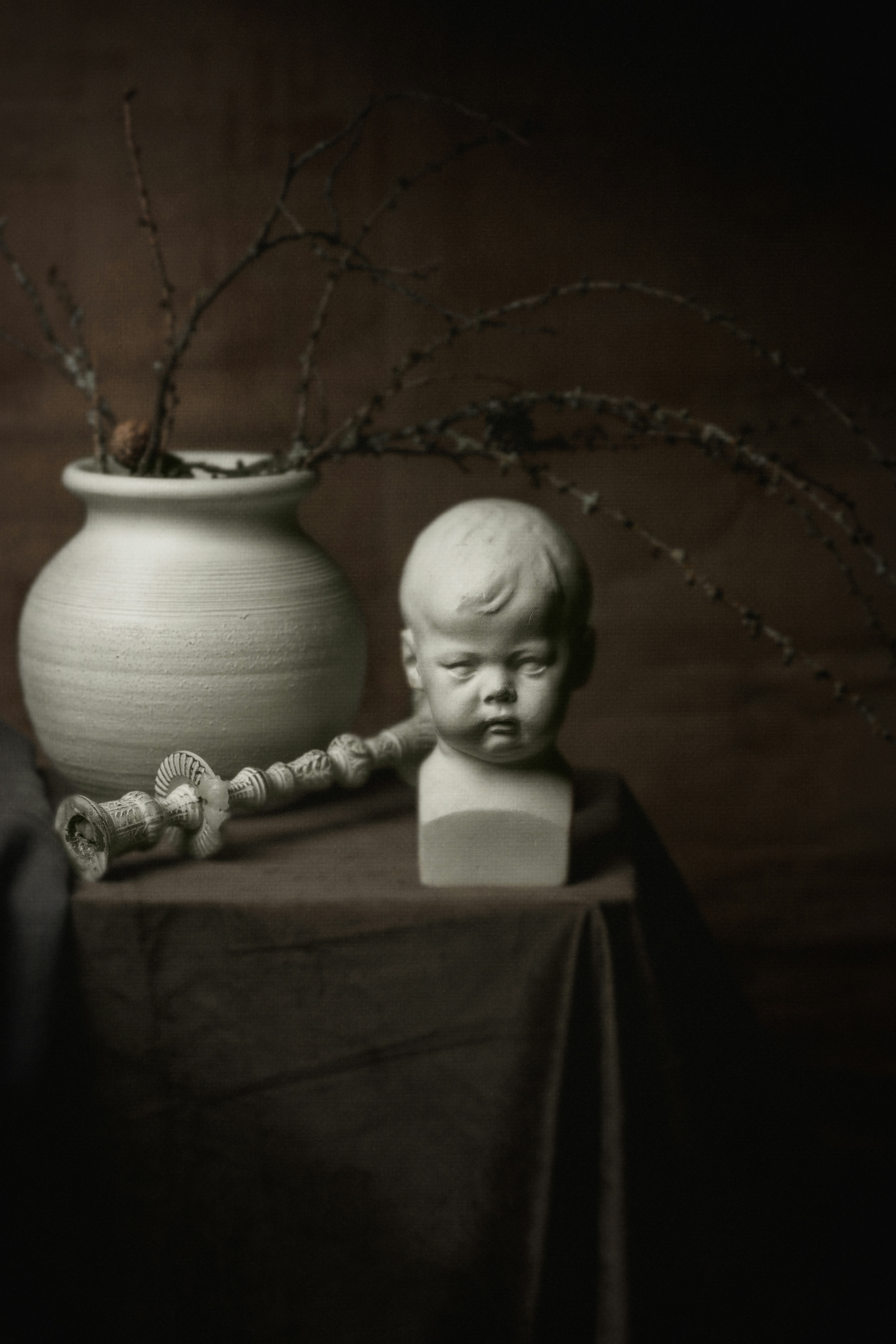 white ceramic figurine on blue textile