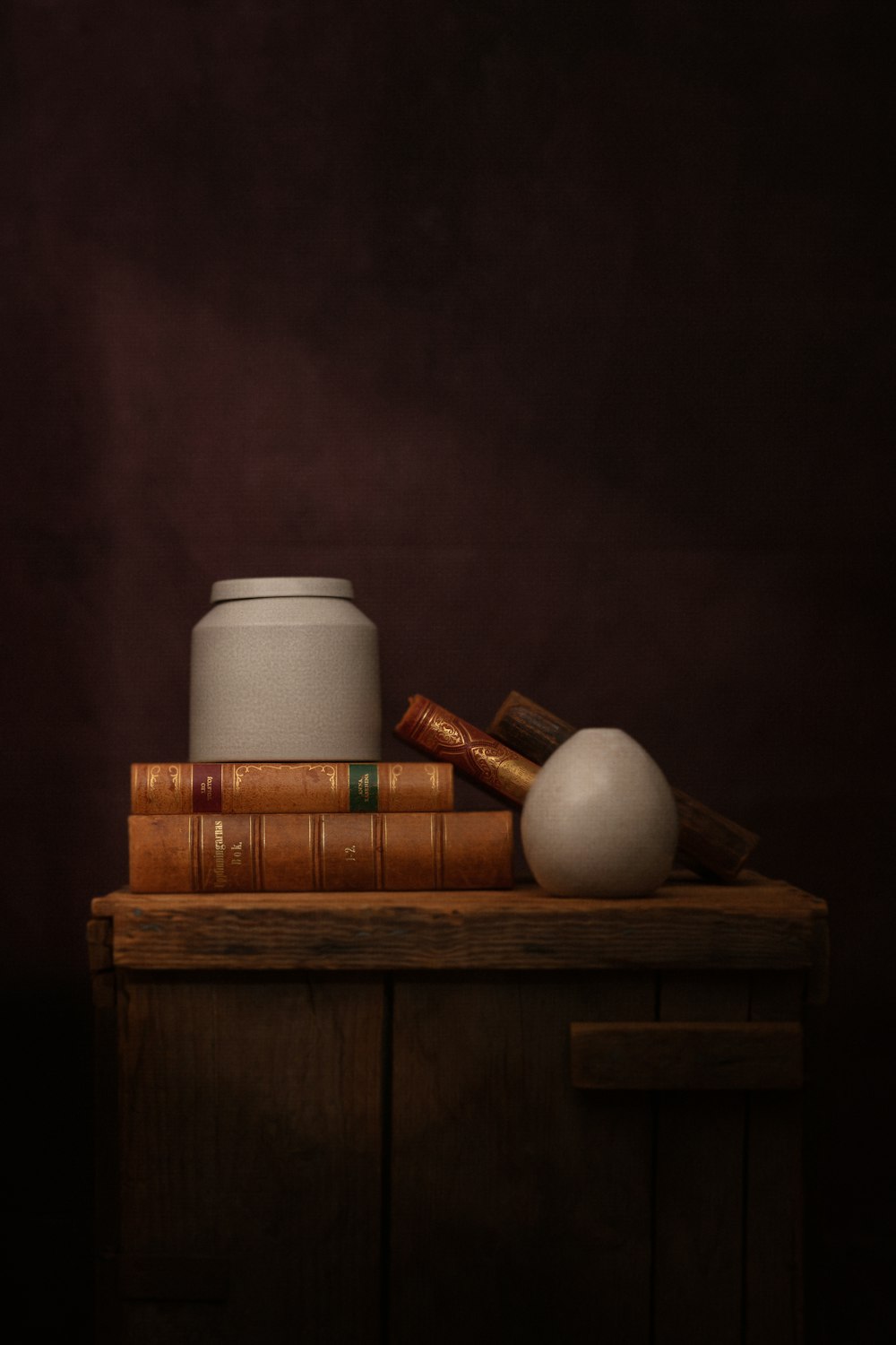 white pillar candle on brown wooden table