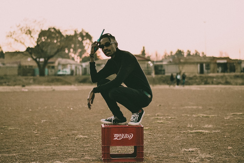 man in black long sleeve shirt and black pants riding on red and black coca cola