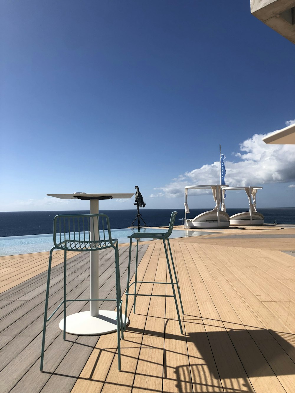 white and brown patio umbrella on brown wooden dock during daytime