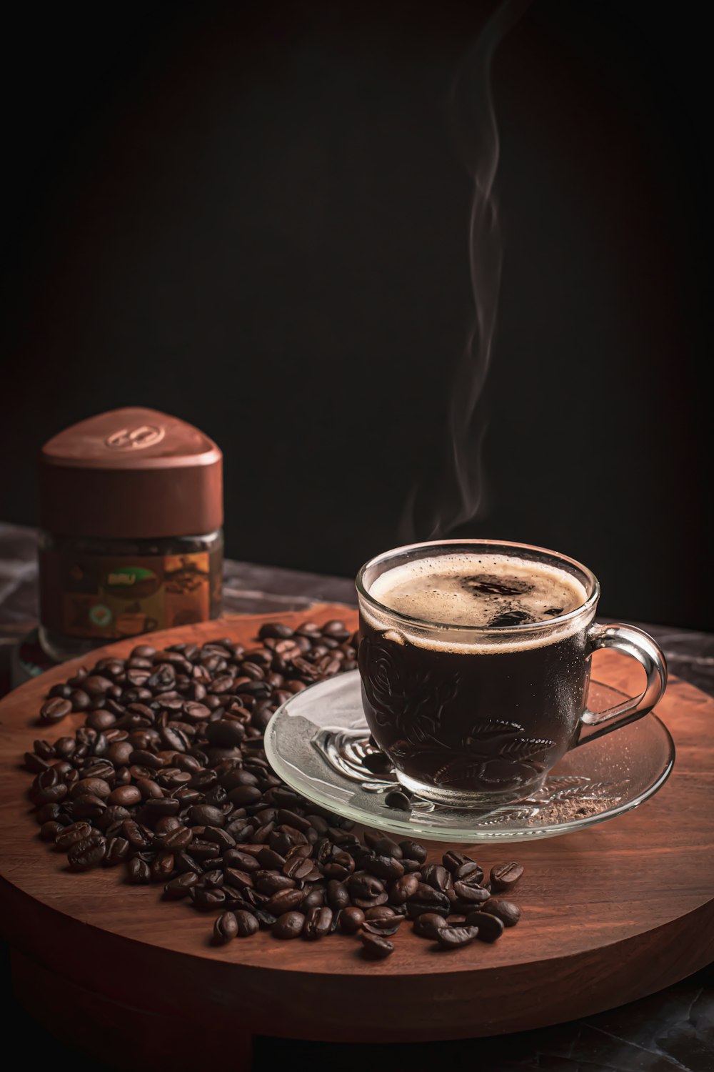 black and white ceramic cup with saucer on brown wooden table