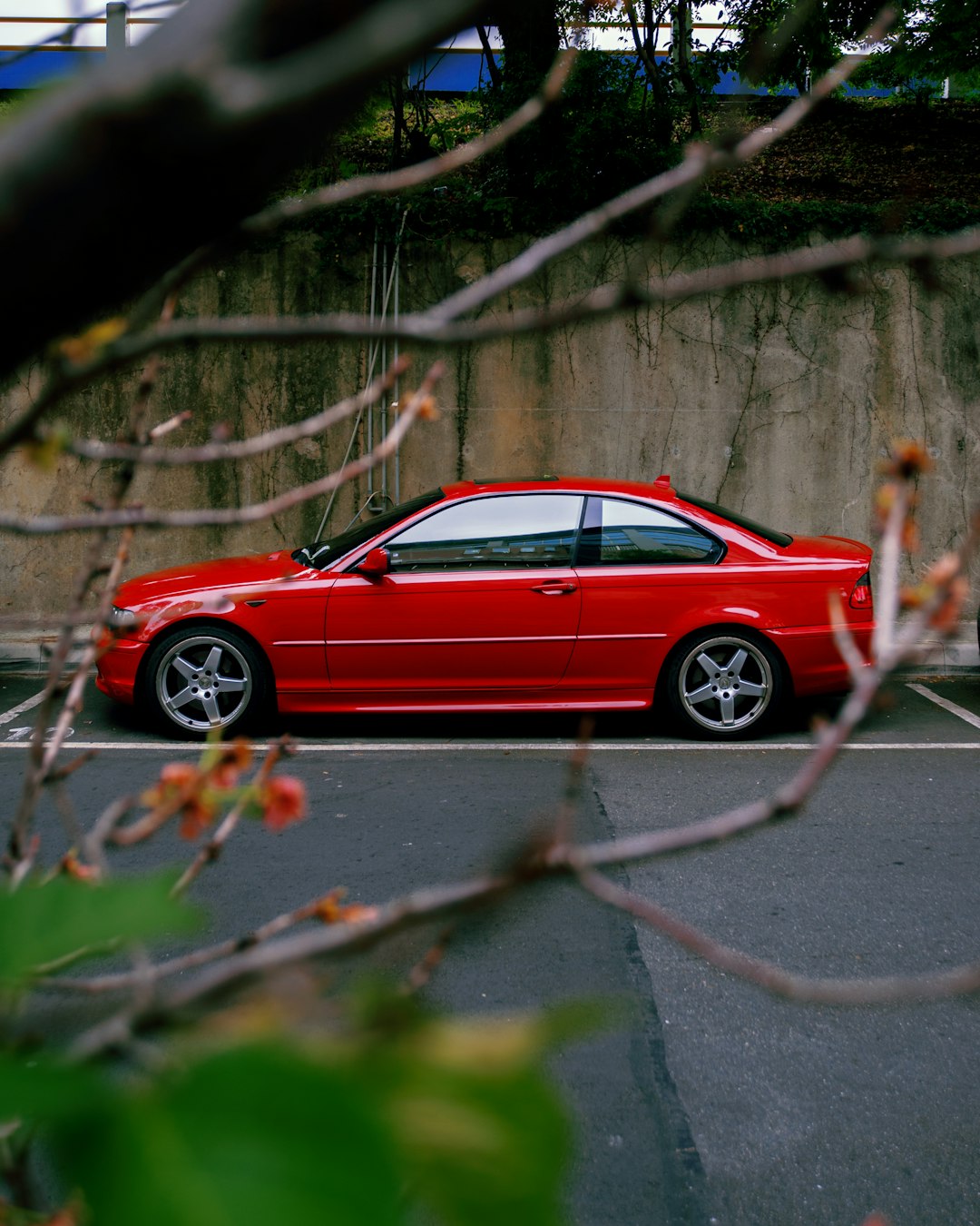 red coupe on gray asphalt road