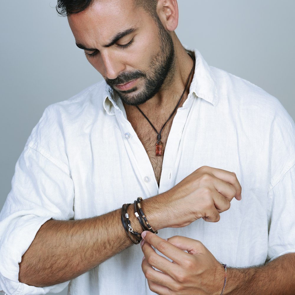 man in white button up shirt wearing silver ring
